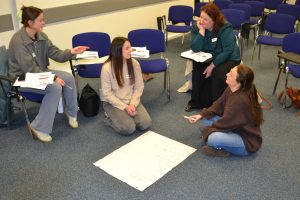 Students on the floor completing group work together
