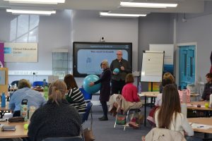 Teachers demonstrating an activity in front of a group