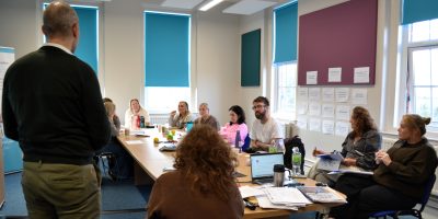 participants chatting around a table during a workshop