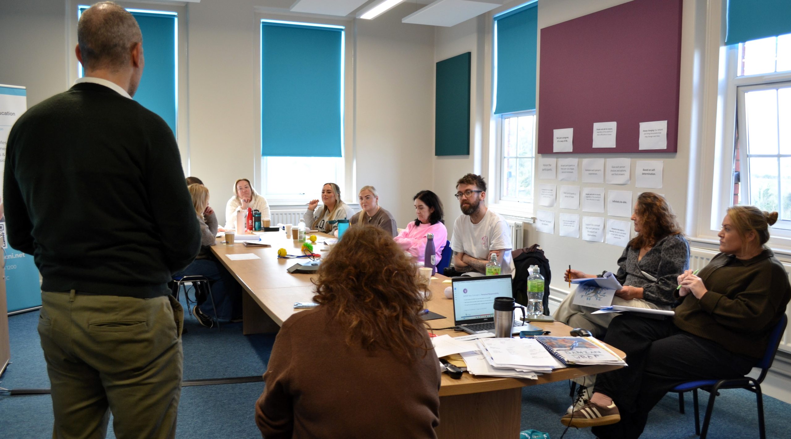participants chatting around a table during a workshop